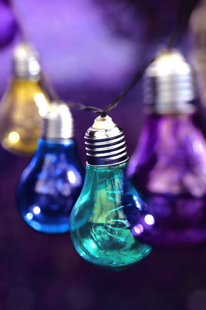Crafting Captivating Headlines: Your awesome post title goes here 4 Vibrant multi-colored light bulbs hanging as festive decoration.